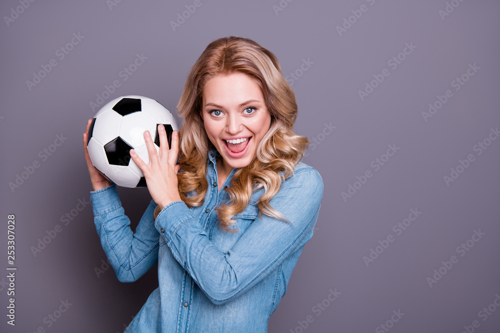 Close-up portrait of nice cute lovely adorable fascinating charming attractive cheerful cheery wavy-haired lady wearing blue shirt holding in hands black and white ball isolated over gray background Close-up portrait of nice cute lovely adorable fascinating charming attractive cheerful cheery wavy-haired lady wearing blue shirt holding in hands black and white ball isolated over gray background