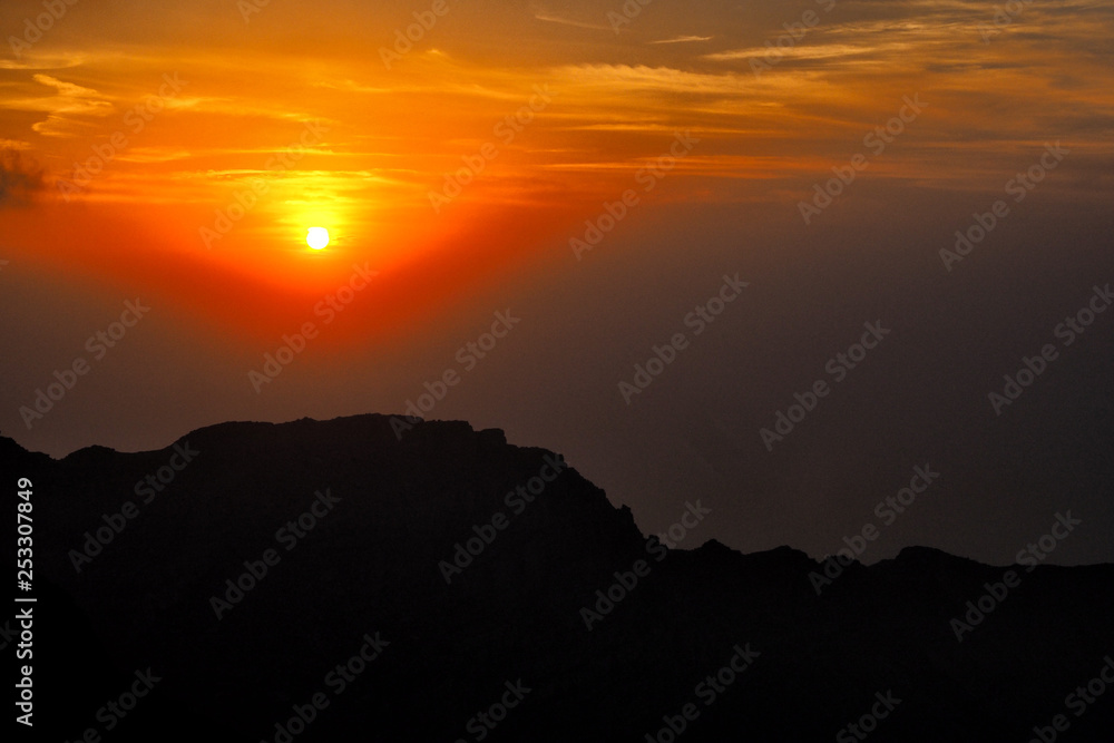 Fantastic sunset in the mountains. Jebel Rahabah. Viewpoint near Jebel Jais. Al Hajar Mountains. Ras Al Khaimah. United Arab Emirates