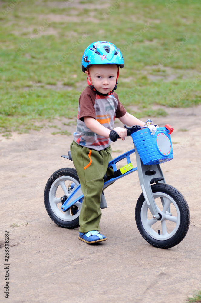 A little boy cycling on his first bike A little boy cycling on his first bike