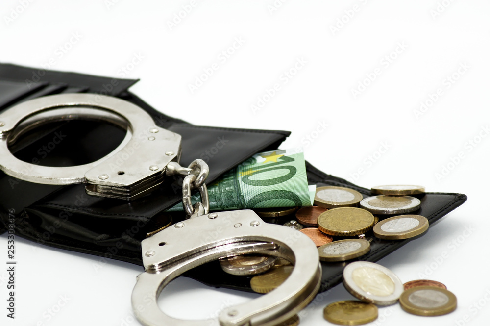 Obraz premium Kriminelle Geldgeschäfte Euro Banknoten und Handschellen