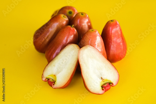 Syzygium Aqueum , Bell fruit or Jambu Air in local Malay language, is a fruit that has a shape like a bell; shot on isolated yellow background. photo