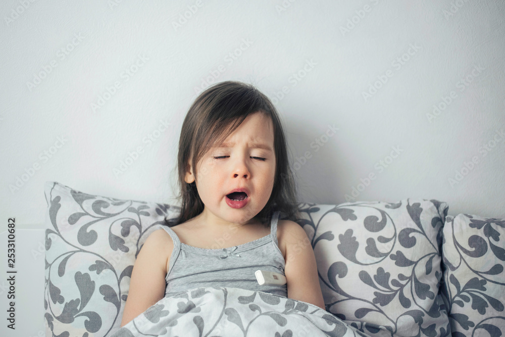 The little girl caught a cold. The girl lies in bed and is ill. The child has a runny nose and cough. The little girl caught a cold. The girl lies in bed and is ill. The child has a runny nose and cough.