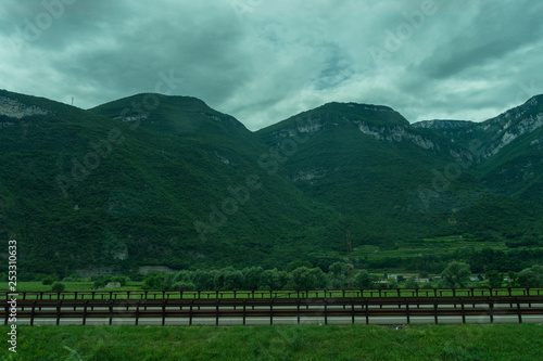 Italy,La Spezia to Kasltelruth train, a wooden bench in front of a mountain