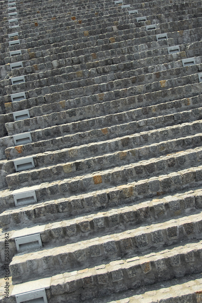 Rounded circular Luxury Stone garden steps. On angle, viewed from the left. Crushed red shale and greenery to the right. Rounded circular Luxury Stone garden steps. On angle, viewed from the left. Crushed red shale and greenery to the right.