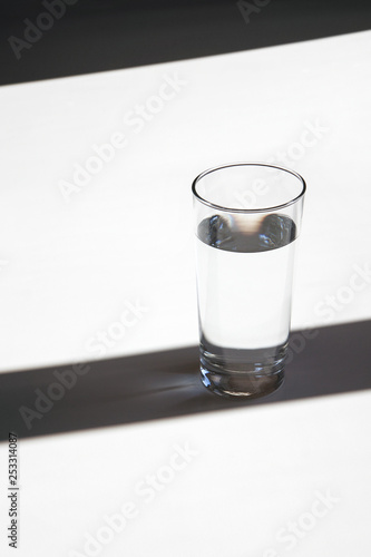 glass of water minimalism style, shadows and lights elegant rhythm vertical picture