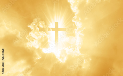 Christian cross appears bright in the yellow sky