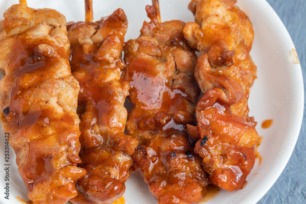 Thai style barbecue grilled chicken and stick on plate Thai style barbecue grilled chicken and stick on plate