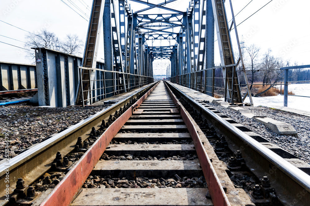 railway rails on a metal bridge go into perspective railway rails on a metal bridge go into perspective