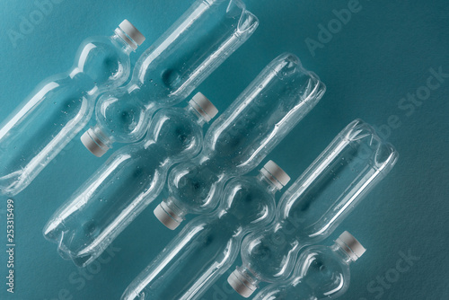 top view of empty plastic bottles on turquoise background