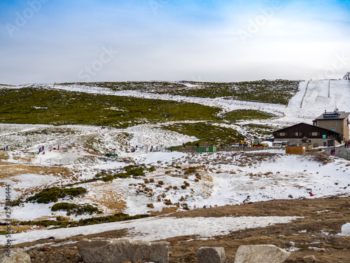 Unrecognizable people gliding on the ice in a slope on the mountain on La Covatilla, Bejar (Salamanca)