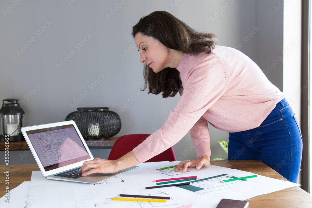 Focused interior designer working on renovation project Focused interior designer working on renovation project