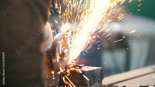 Industrial concept. Construction site. The man worker grinding. Fire sparkles © KONSTANTIN SHISHKIN