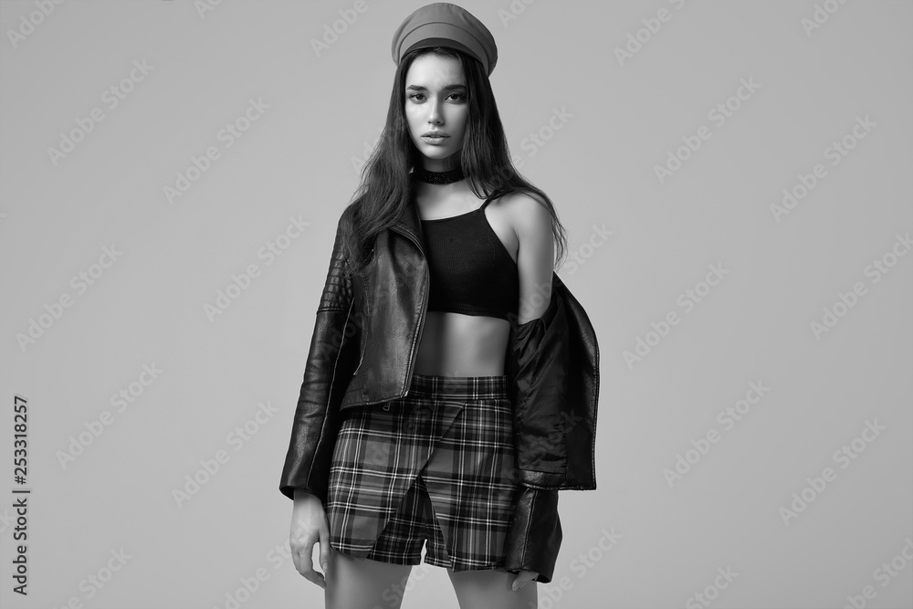 Fashion brunette woman wearing a leather jacket and red hat Fashion brunette woman wearing a leather jacket and red hat