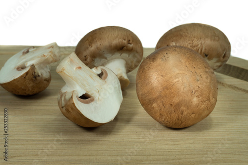 Fresh whole and halved brown Baby Bella mushrooms