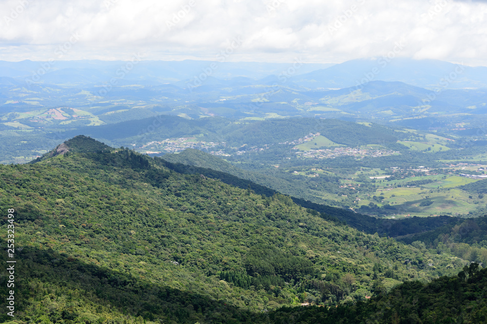 Rocky and green landscape of the mountains of Pedra Grande park in Atibaia, Sao Paulo, Brazil. In the back ground aerial view of the city of Atibaia
