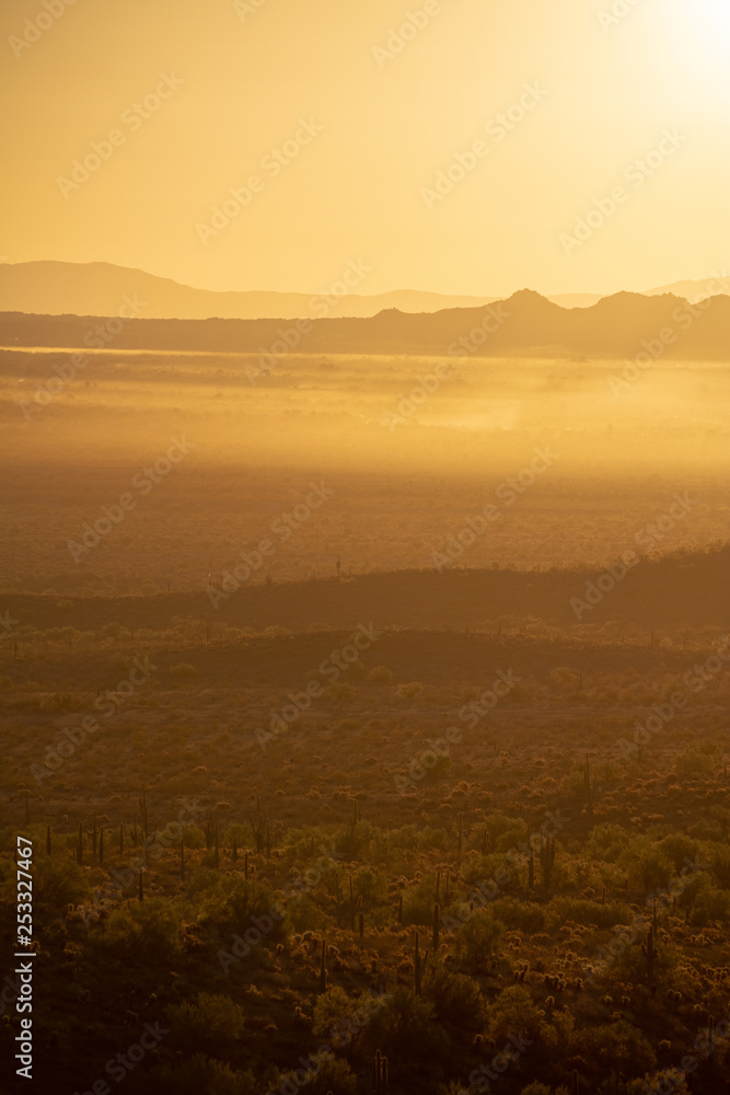 The sun rising over the mountains of the Arizona desert with natural warm hues.