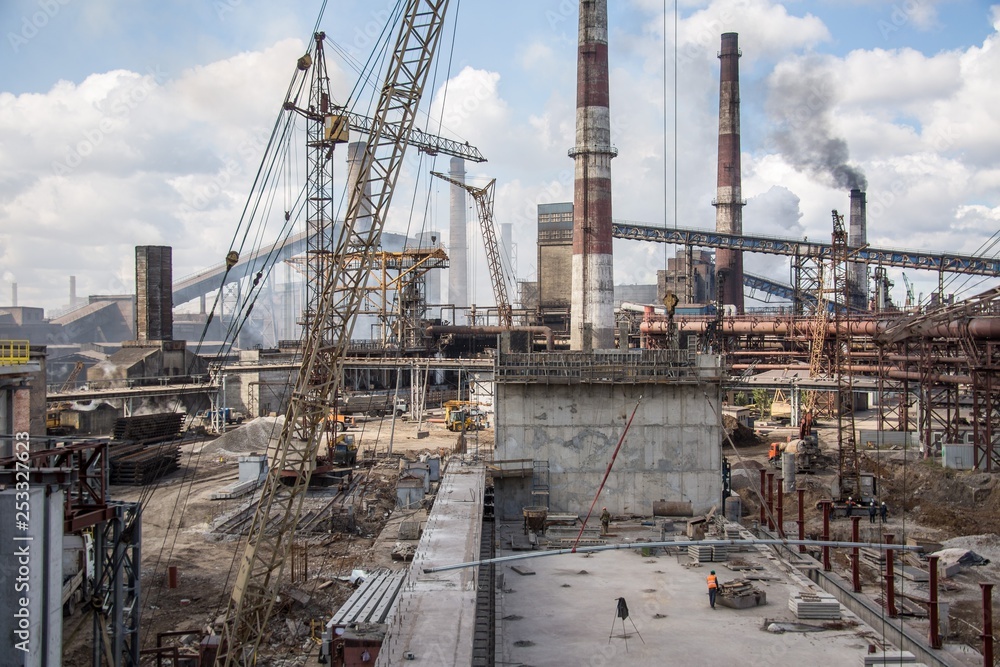 landscape, panorama, view of factory slums with metal hulls and machines for the production of the coking industry, smoking pipes and reconstruction of a plant in Ukraine