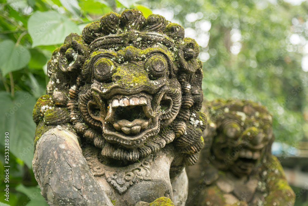 Portrait of balinese statue of barong god made of overgrow stone. Portrait of balinese statue of barong god made of overgrow stone.