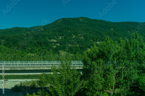 Italy La Spezia to Kasltelruth train  a large green field with trees in the background
