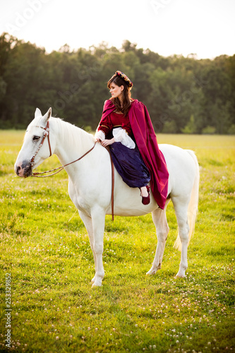 Medieval Princess Sitting on a White Horse © IdeaBug, Inc.