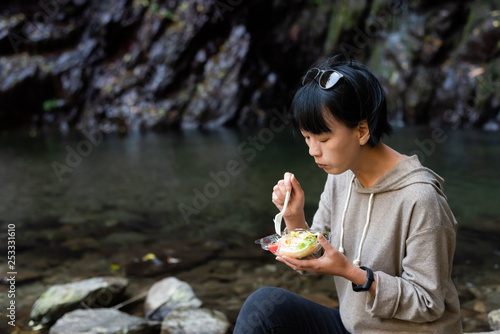 Asian woman eat salad