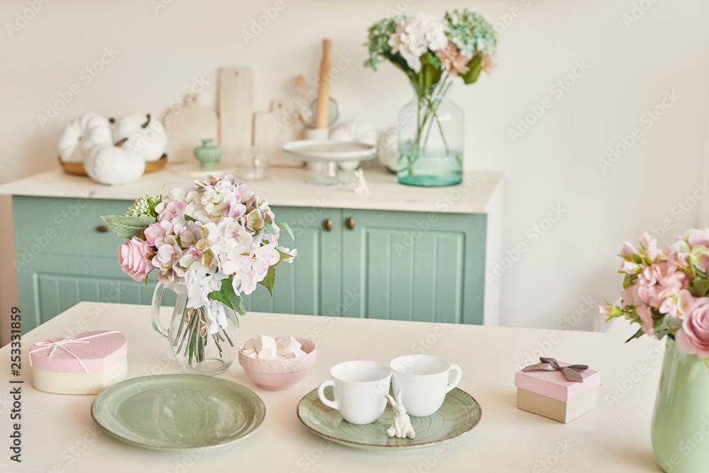 bright kitchen in the style of Provence, on the table dishes and a bouquet of flowers in a vase bright kitchen in the style of Provence, on the table dishes and a bouquet of flowers in a vase