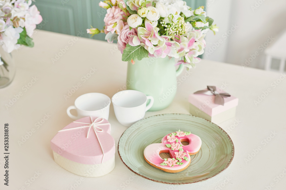 Gingerbreads for March 8 in the bright kitchen with flowers Gingerbreads for March 8 in the bright kitchen with flowers