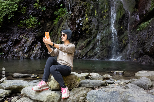 woman selfie near the waterfall