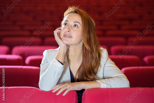 pretty young woman alone in cinema hall