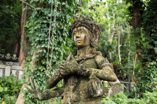 Stone idol of multiarm god in Bali, Indonesia.