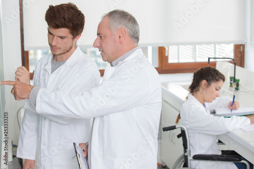 science student in wheelchair working at university