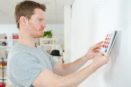 man picking the color for his wall