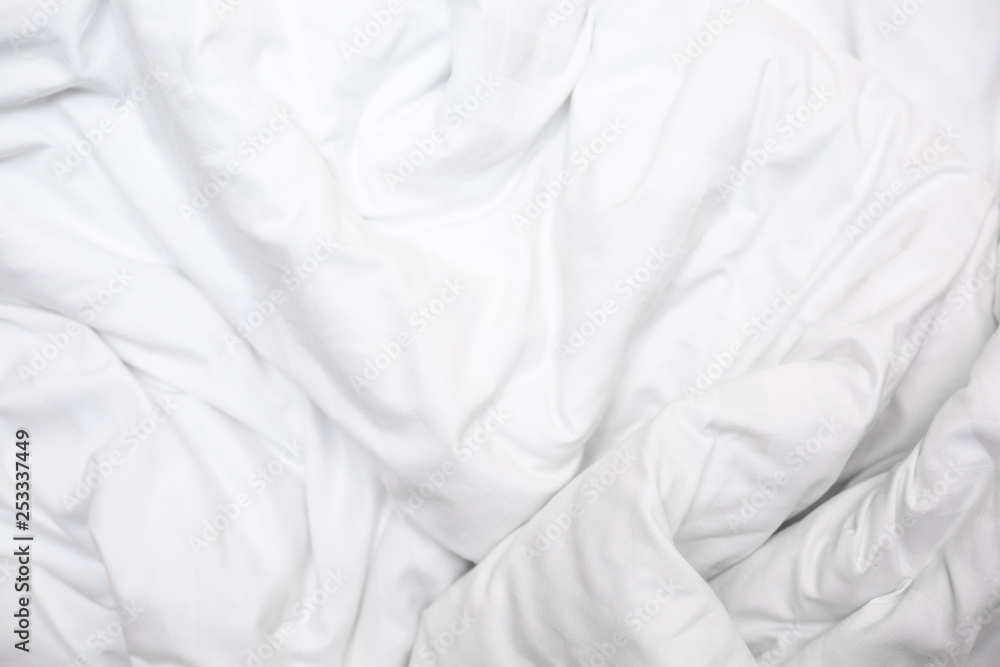 Top view of a messy bedding sheet after night sleep,white fabric crease