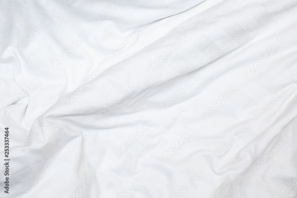 Top view of a messy bedding sheet after night sleep,white fabric crease Top view of a messy bedding sheet after night sleep,white fabric crease