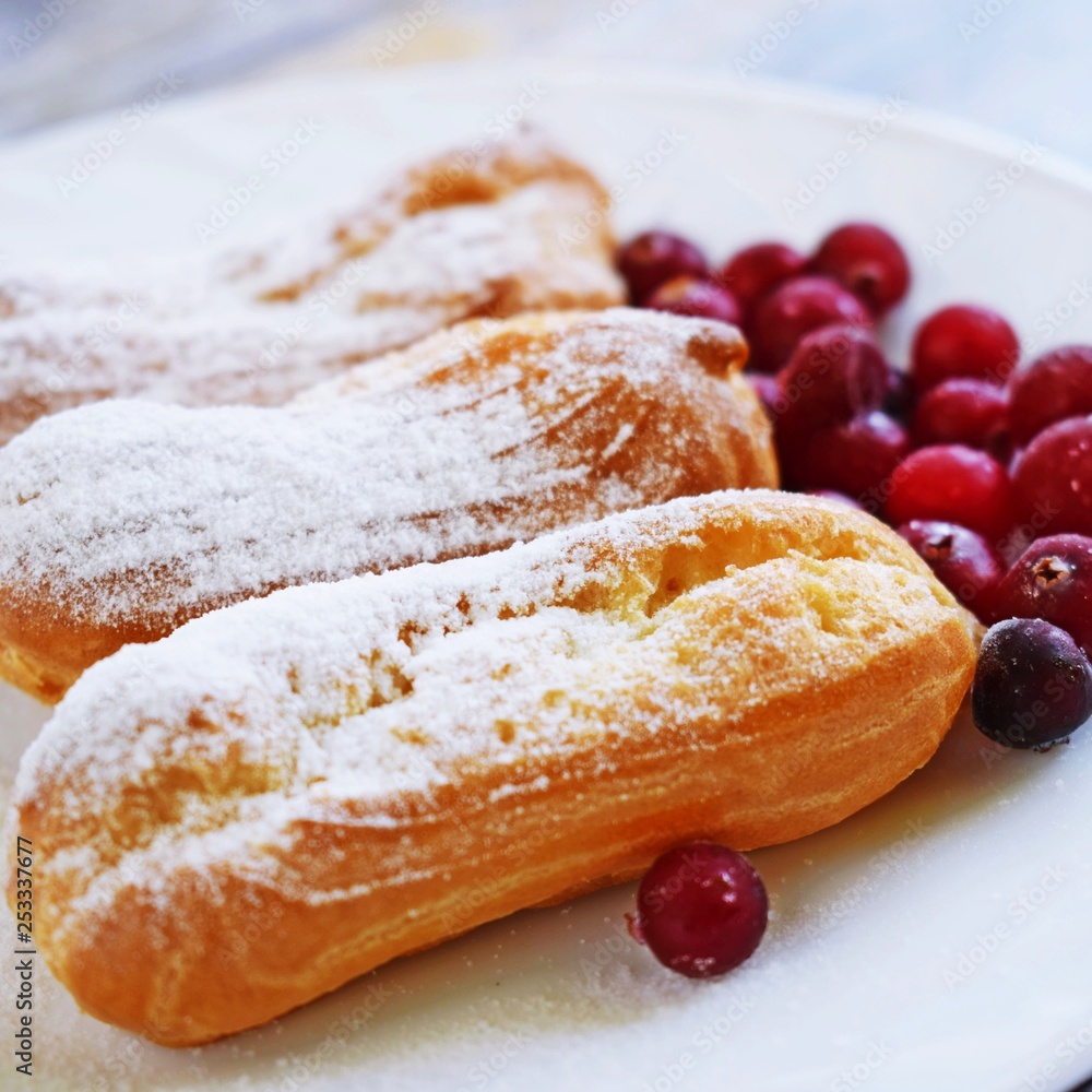 Custard tarts and fresh berries on a white plate. Custard tarts and fresh berries on a white plate.