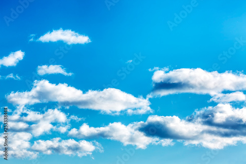Bright turquoise sky with clouds, background