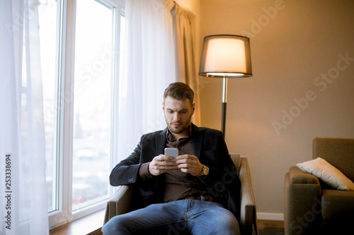 Young man using mobile phon...