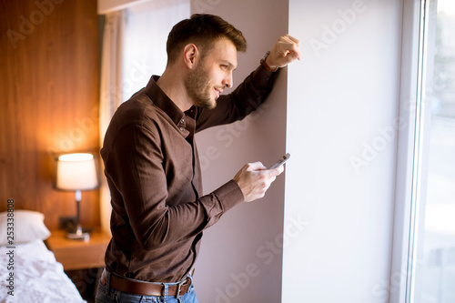 Young man using mobile phon...