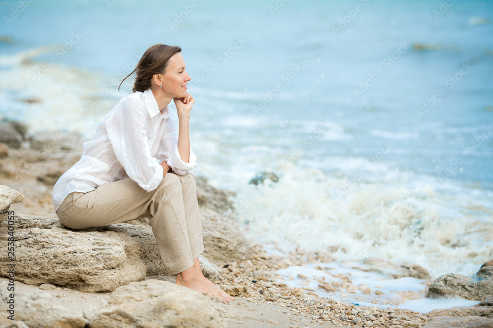 Young woman enjoying life on the ocean coast