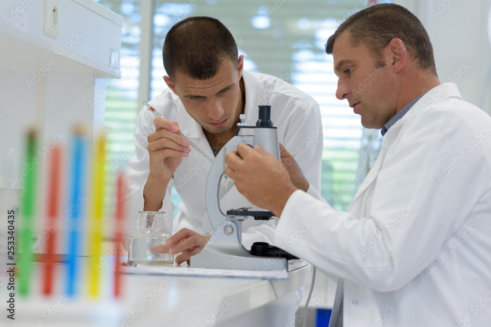 two scientists in a modern laboratory two scientists in a modern laboratory