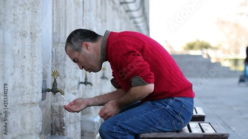 Muslim man taking ablution for prayer