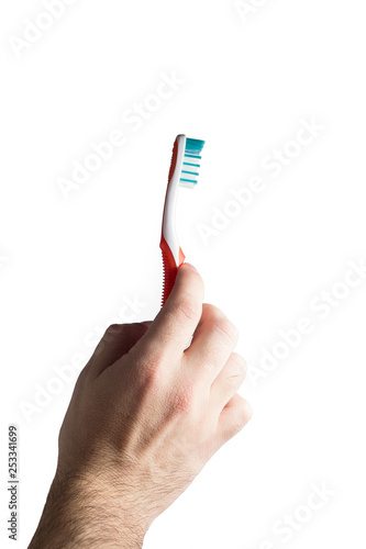Hand holding new toothbrush on white background