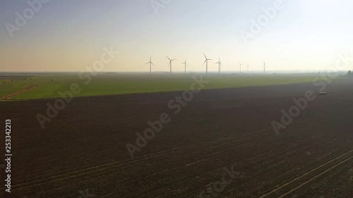 Aerial sequence featuring wind turbines in operation along the Essex coastline at Bradwell-on-Sea.
