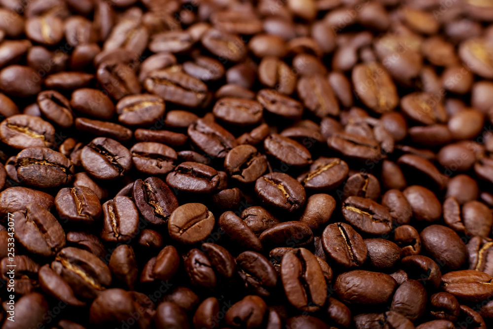 Fototapeta premium Aroma roasted coffee beans, brown background. Soft focus close up.