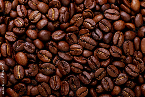 Aroma roasted coffee beans, brown background. Soft focus close up. © Plutmaverick
