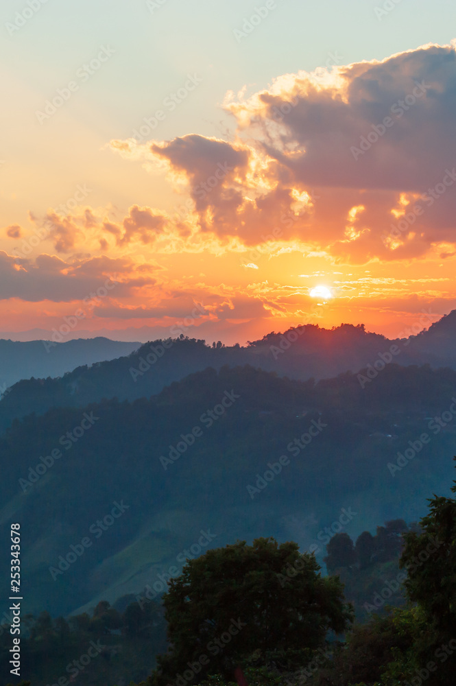 Golden sun setting over mountains near Thailand and Myanmar border.