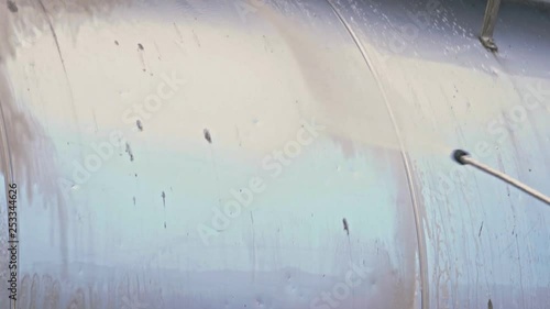 A worker washes a chester of the track close-up