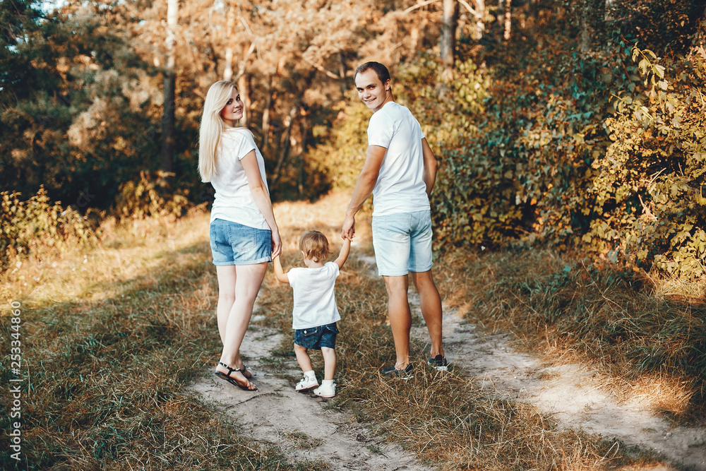 Cute family playing in a summer park Cute family playing in a summer park