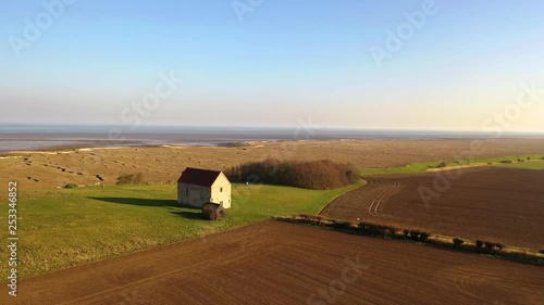 Aerial sequence featuring The Chapel of St Peter-on-the-Wall, Bradwell-on-Sea, Essex. It is a Grade I listed building and among the oldest largely intact Christian churches in England, built in 660.