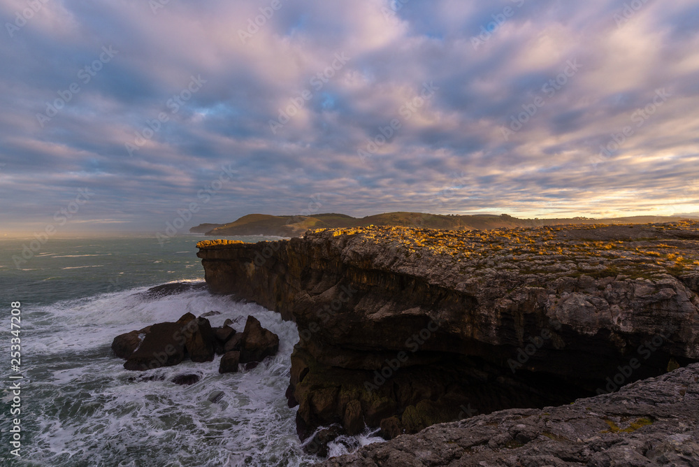 Rocky coast of Ajo Cape at sunset, Cantabria, Spain